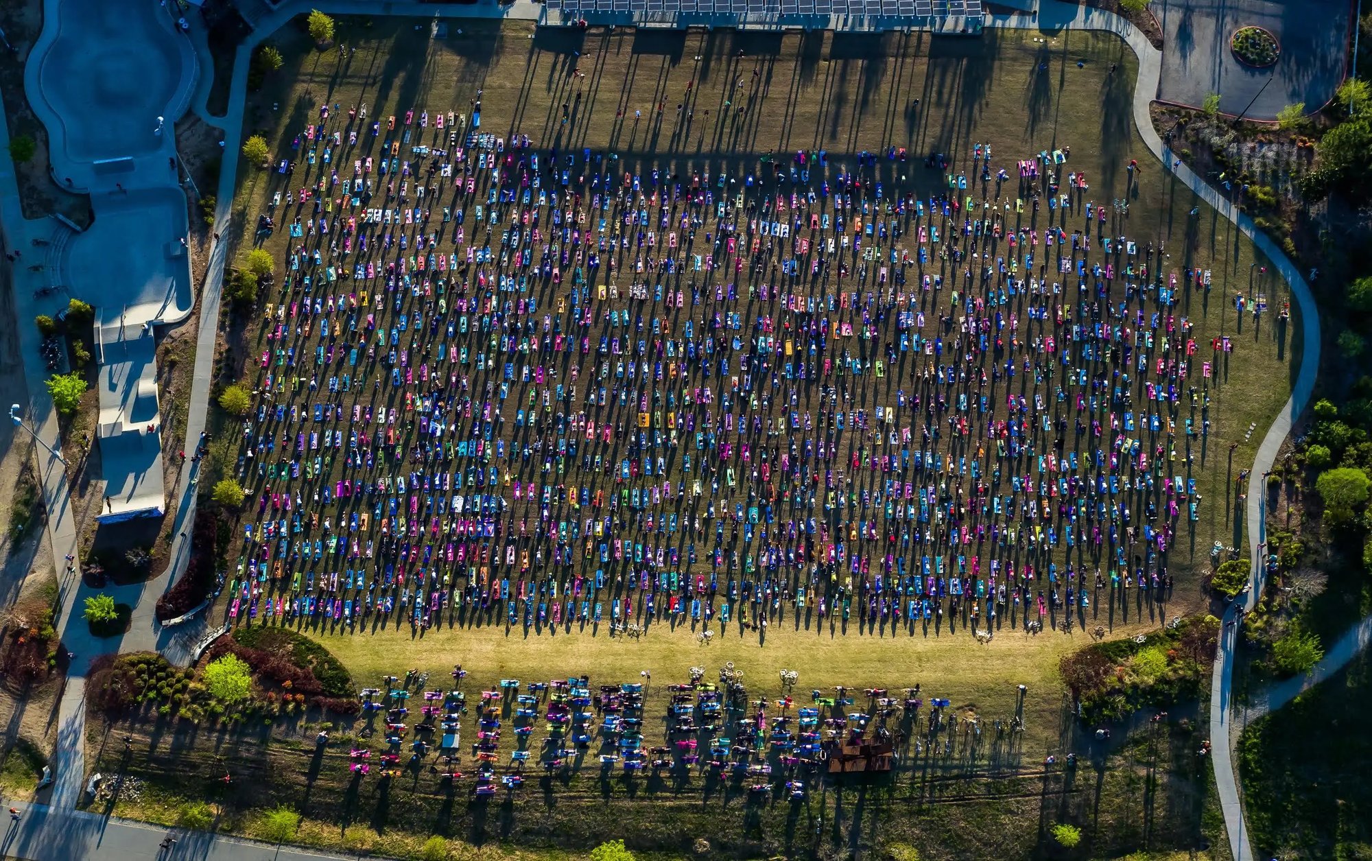 Overhead shot of a park filled with many people doing yoga